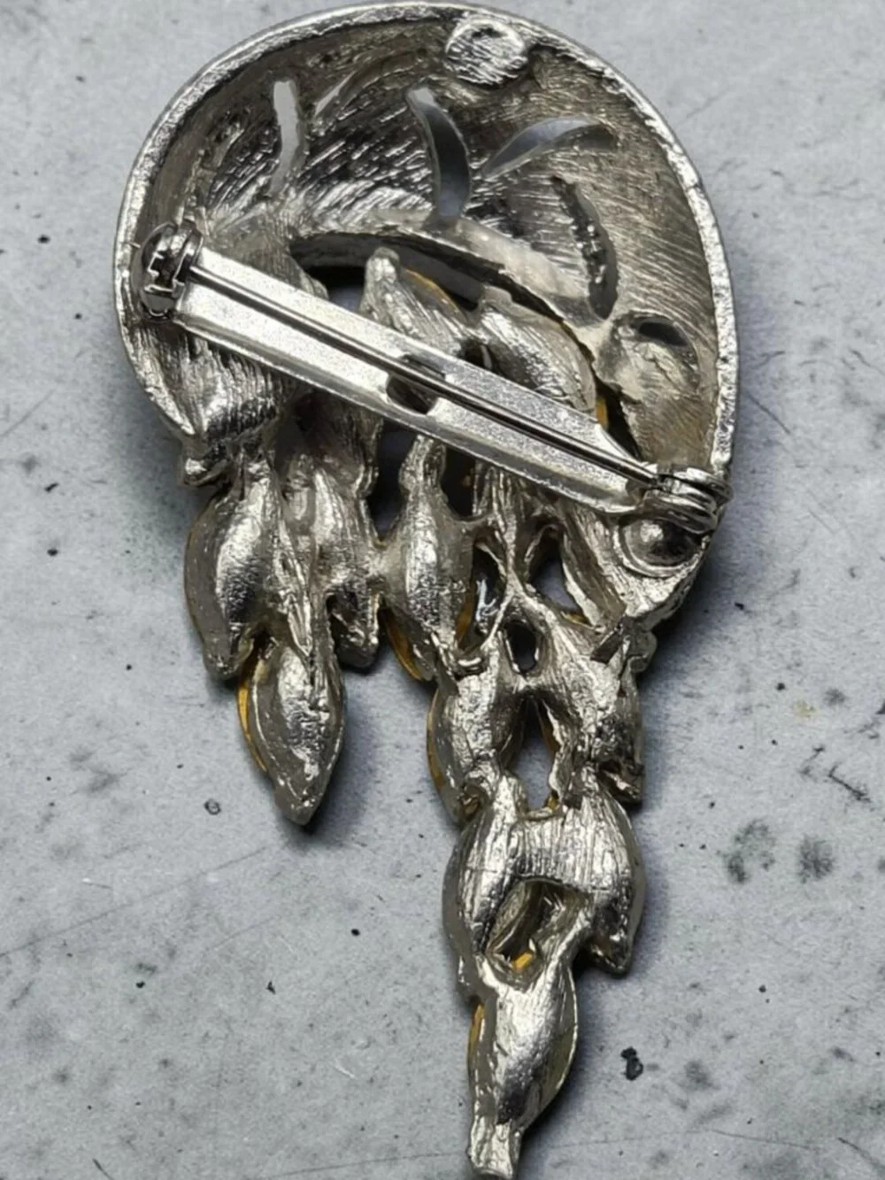 None this brooch